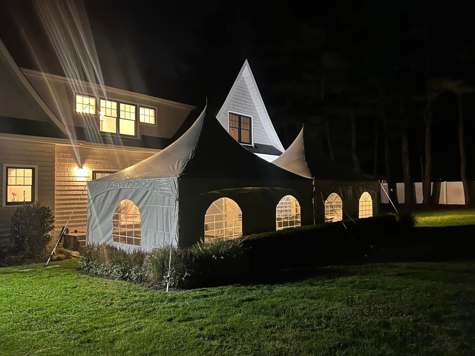 20 by 20 high-peak tent: Night, sides on, house behind