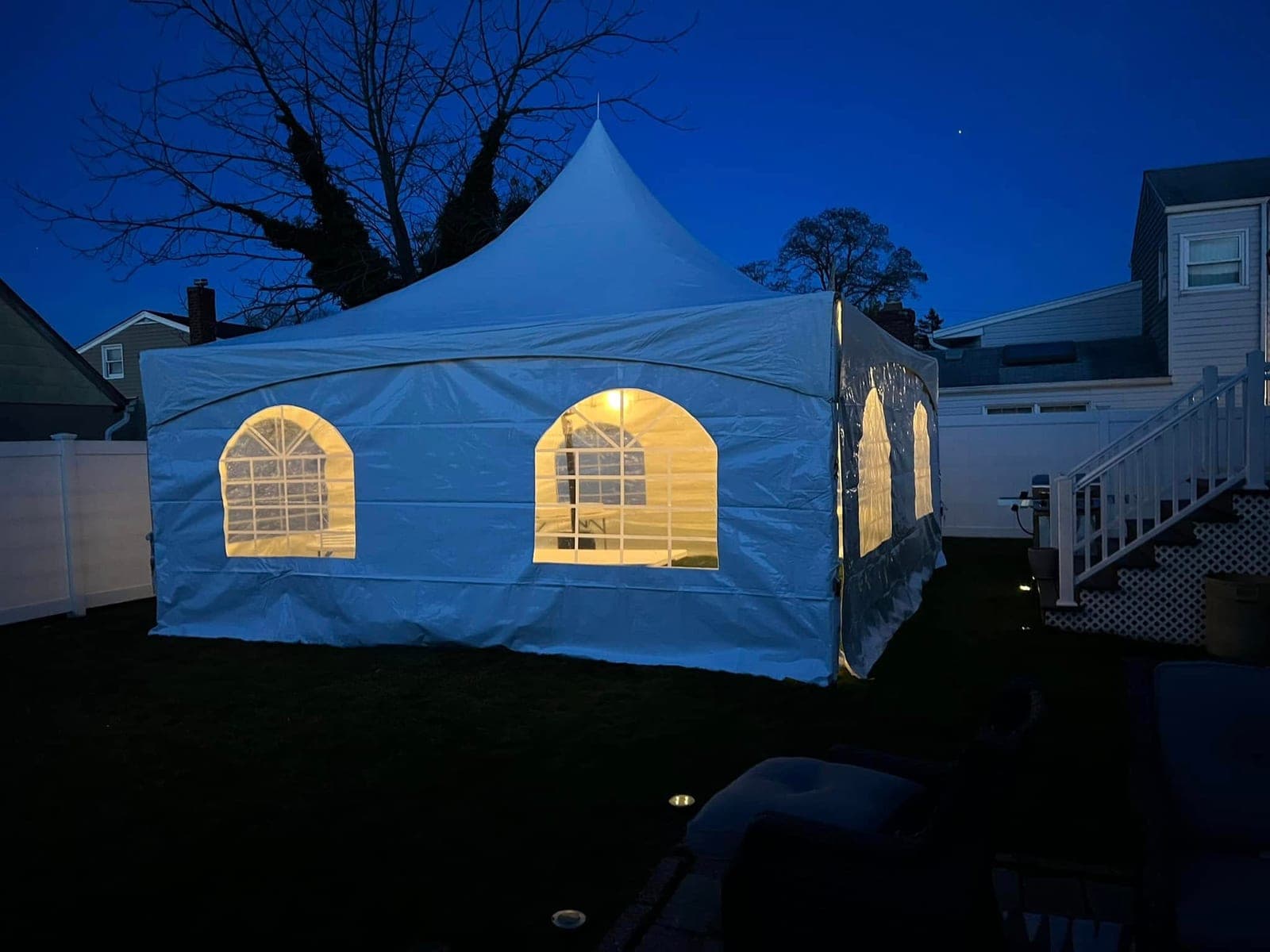 20 by 20 high-peak tent: Lit up after dark, sides on