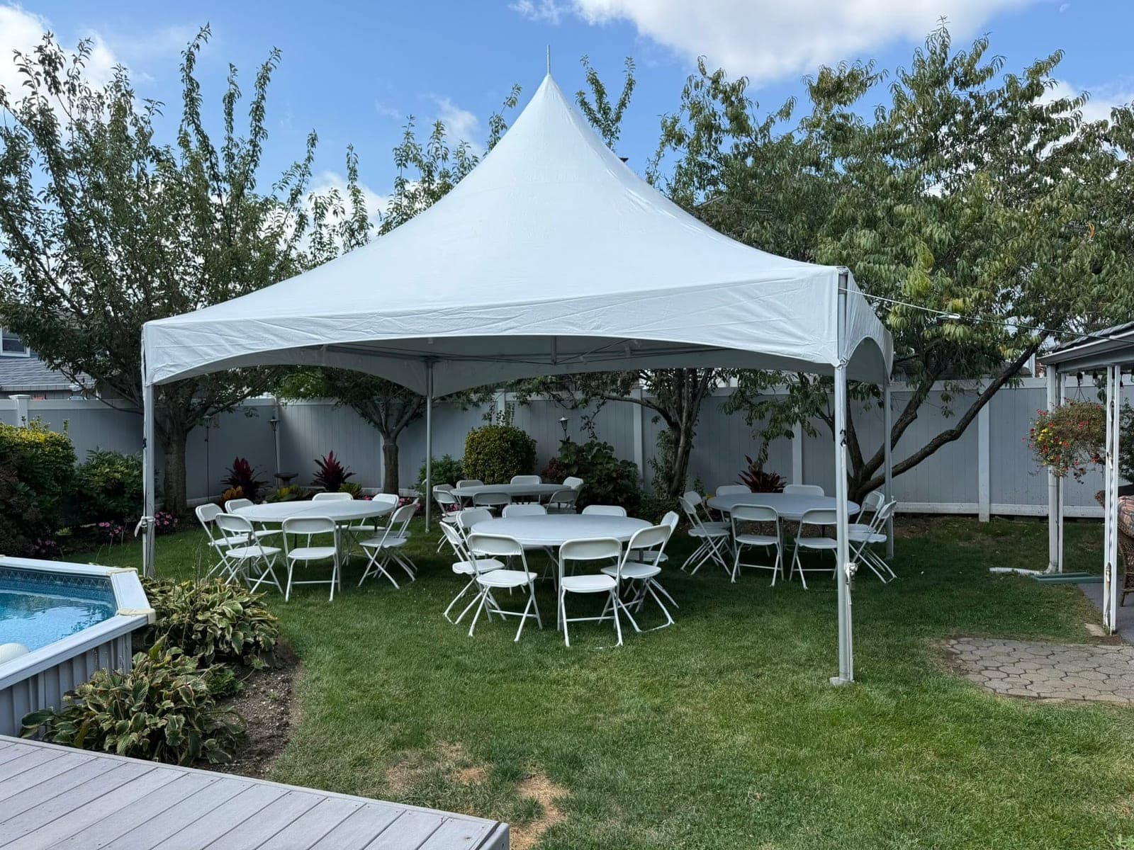 20 by 20 high-peak tent: Rounds and chairs, backyard