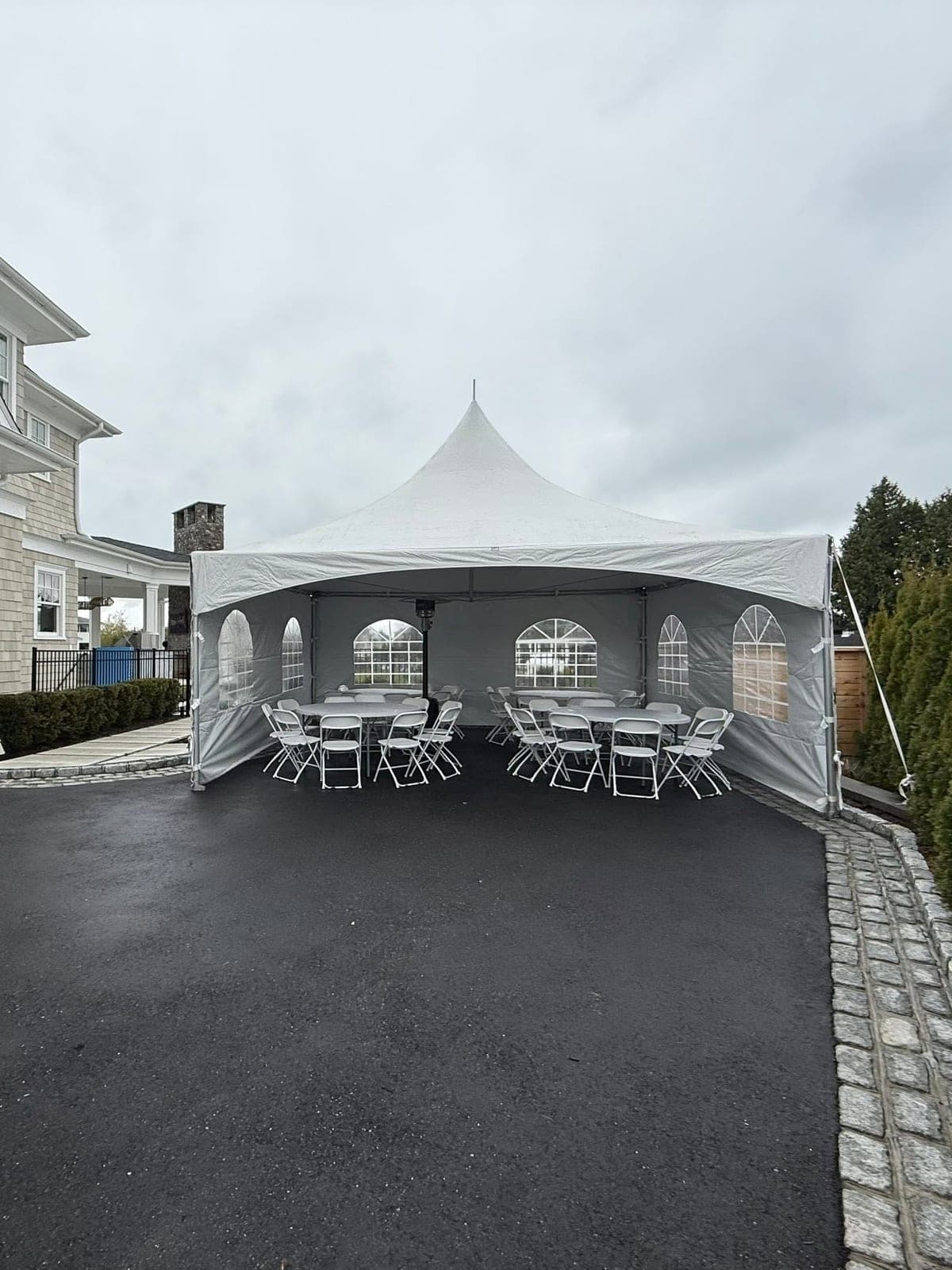 20 by 20 high-peak tent: Sides on, gravel driveway
