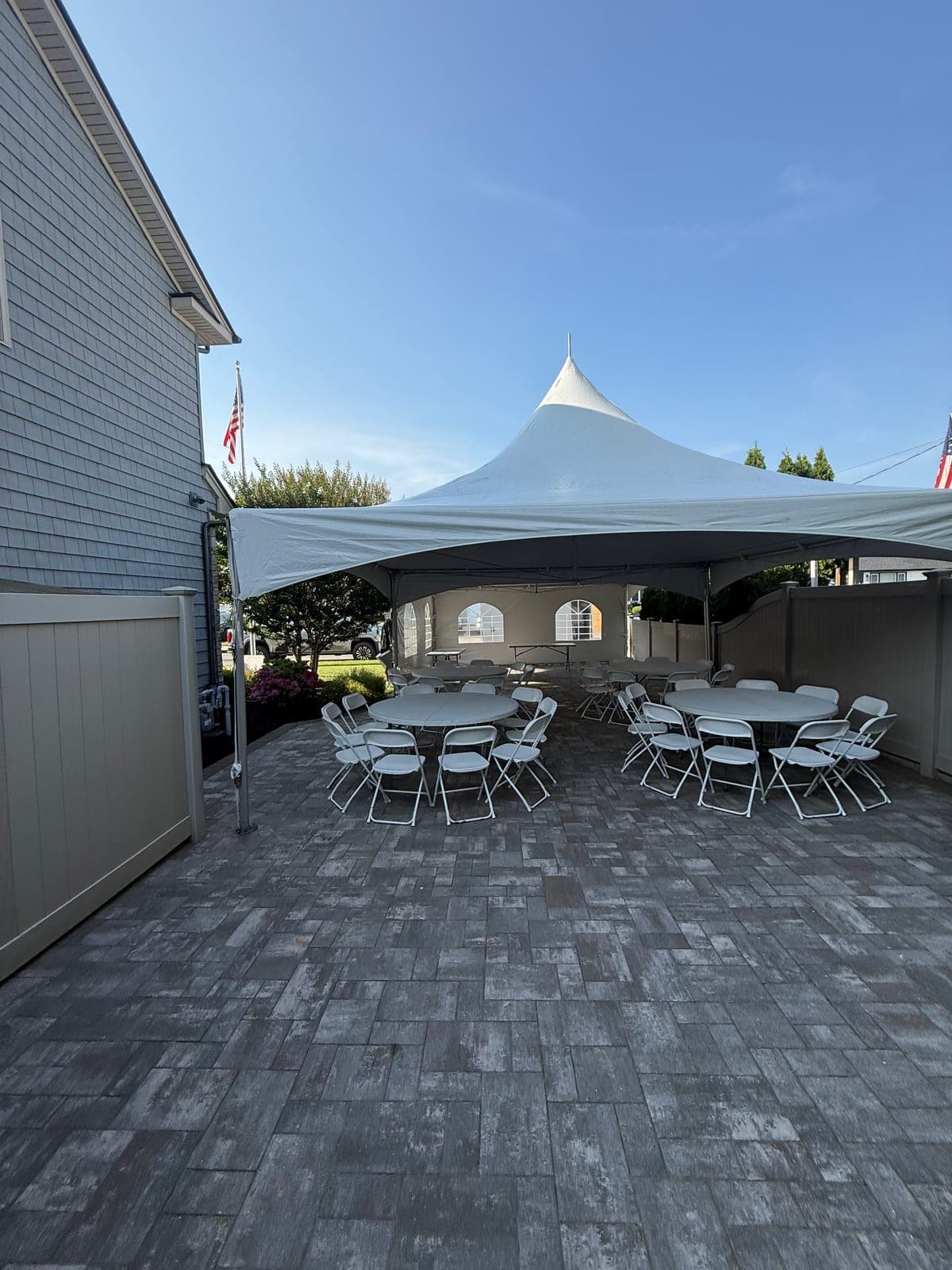 20 by 40 high-peak tent: 20×40 on the pavers, rounds set for dinner