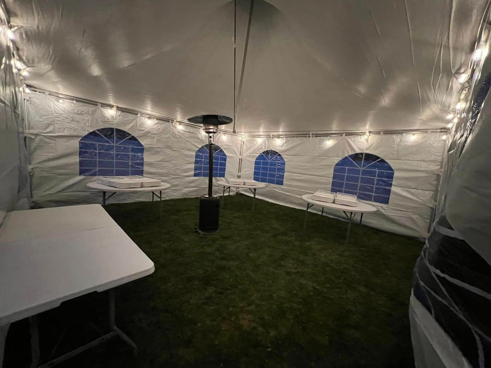 Inside a Tents UP tent: Heater, string lights, sides