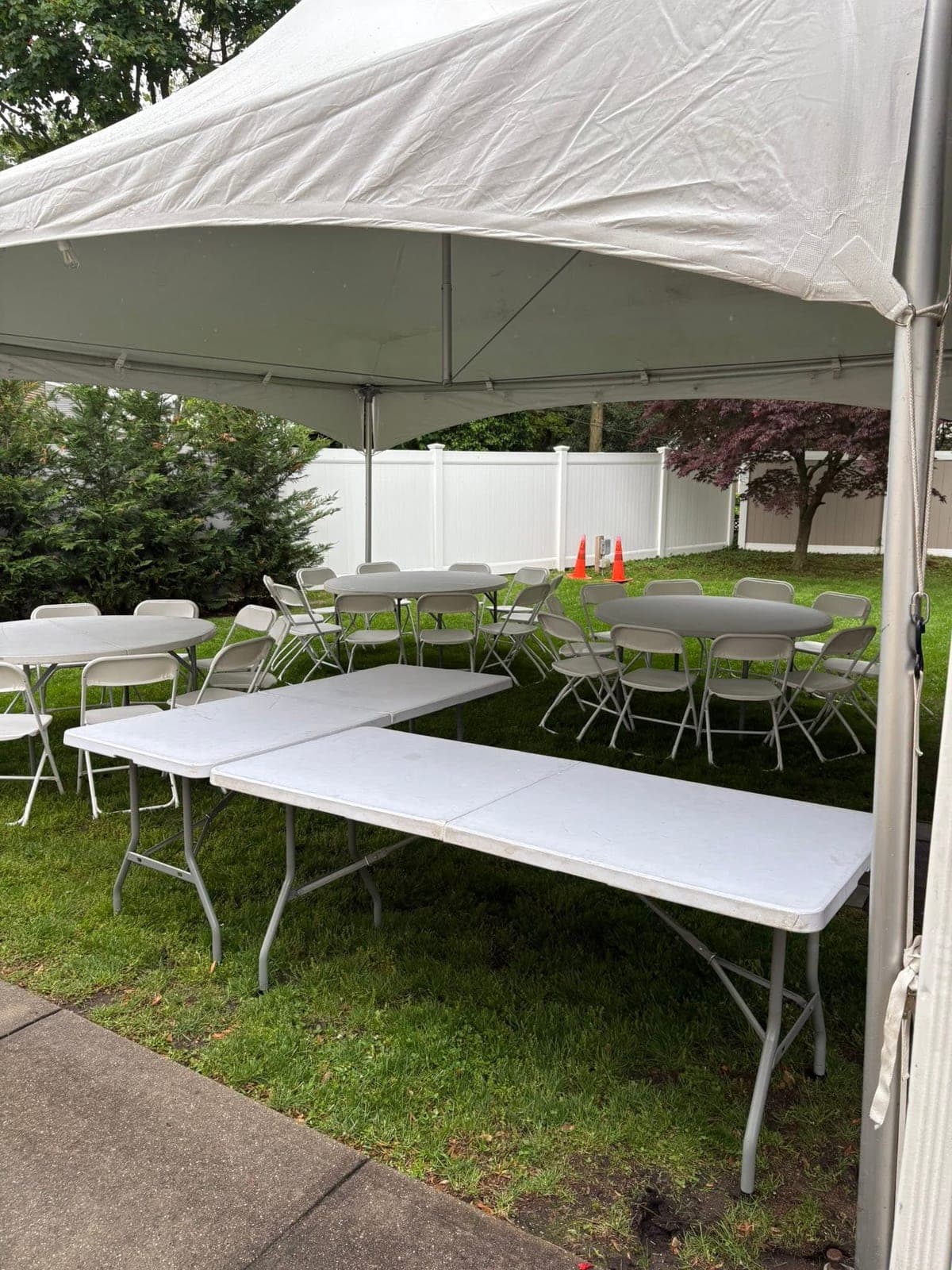 Inside a Tents UP tent: Long tables ready