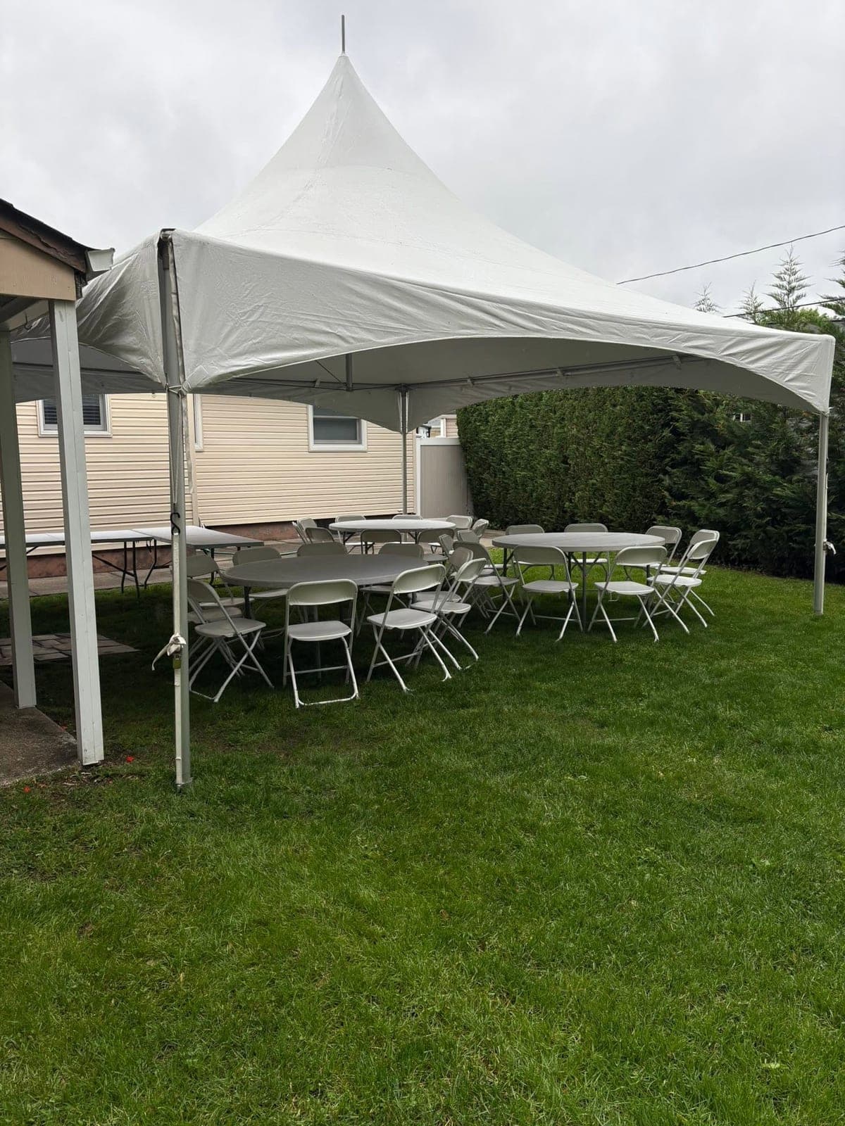 Inside a Tents UP tent: Long tables on the lawn